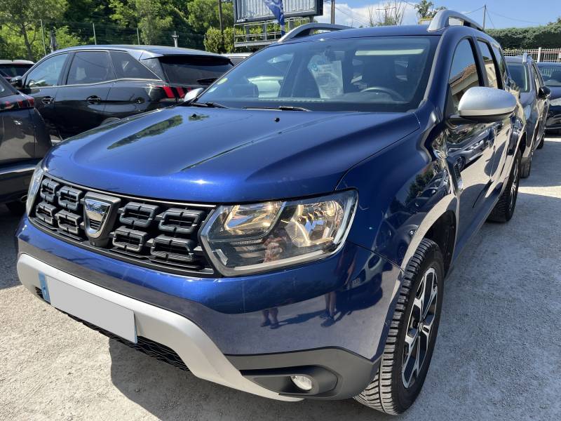 Voiture d’occasion DACIA DUSTER I Ph2 1.5 Blue DCI 116 Prestige. BV6. 5p. Avec GPS Europe tactile et Radars AV + AR + Caméra de Recul ainsi que Crochet d’Attelage AR. Garantie 12 Mois.
